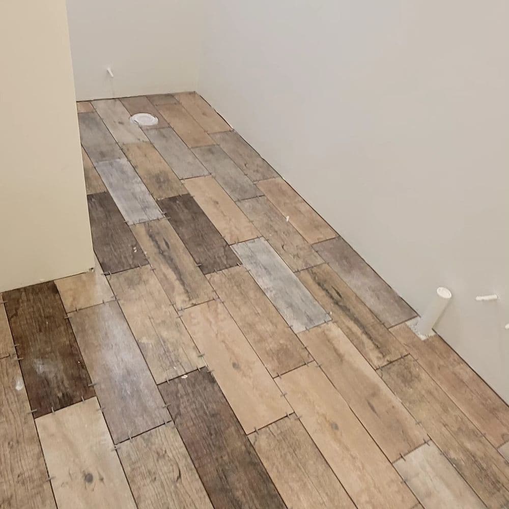 Wooden floor installation with varying shades in a modern interior space.