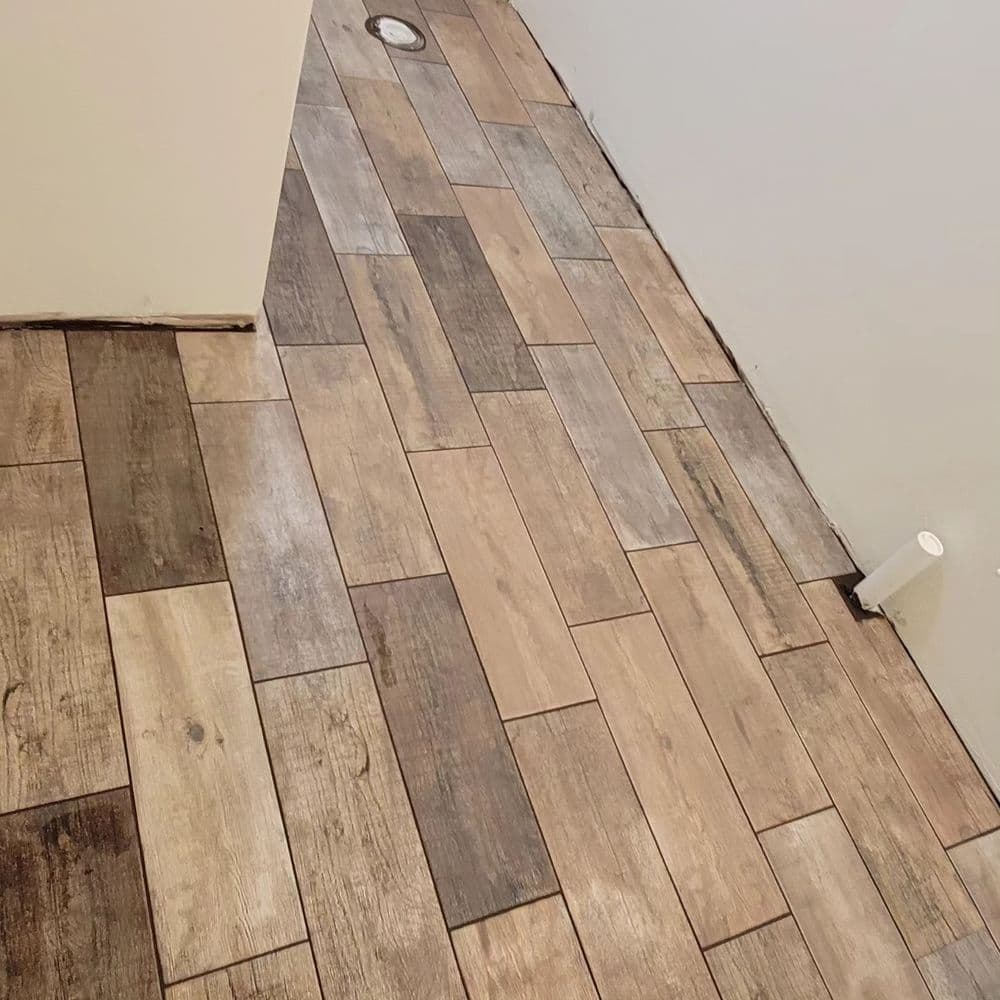 Wooden tile flooring installation in a modern interior with neutral colors and natural finish.